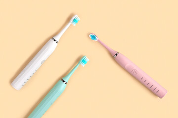 Electric Toothbrush. Top View, Flat Lay, Copy Space. Dental Care Supplies on Beige Pastel Studio Background. Oral Hygiene, Gum Health, Healthy Teeth. Modern Dental Ultrasonic Vibration Tooth Brush Set