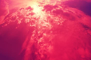Beautiful cloudy sky at sunset. Viva magenta trendy color. Sky texture. Abstract nature background