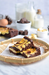 A chocolate cheese brownie or simply a brownie is a chocolate cheese  baked confection. Brownies come in a variety of forms and may be either fudgy or cakey, depending on their density. 

