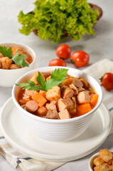 Home made tomato soup with prawns, sausages, ham served with a family recipe
