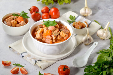 Home made tomato soup with prawns, sausages, ham served with a family recipe
