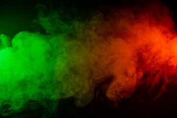 Red yellow green smoke on a black background.