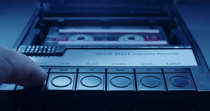 Cassette Tape Inserted Into Player In Blue Light
