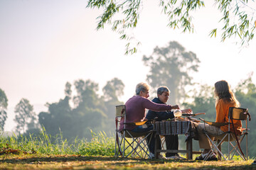 mother and children lifestyle in vacation camping concept, nature, woman person family are happy fun to eating picnic breakfast food at outdoors summer travel, girl with adventure trip holiday leisure