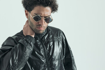 casual man touching his neck with mad look