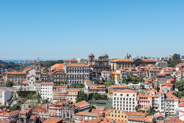Fototapeta na wymiar Stunning views from a lookout towards the historical buildings and residences with the iconic terracotta rooftops, the town's most popular architectural feature in Porto, Portugal
