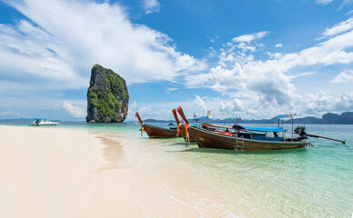 Fototapeta na wymiar Thai traditional wooden longtail boat and beautiful sand beach in Krabi province. Thailand.