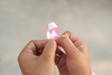 pink bow in female hands international women's day