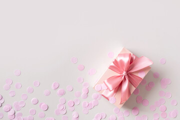 Pink box with confetti on grey background