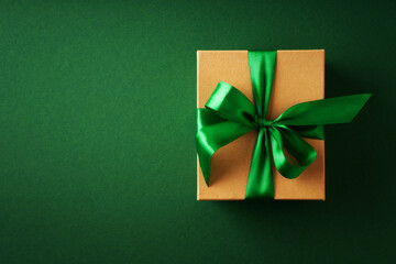 Saint Patrick day concept flat lay with gift box close up on green background