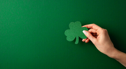 Saint Patrick day flat lay concept with shamrock clover on green background