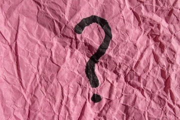Question mark drawn on a pink paper. Curiosity, uncertainty and confusion concepts. Conceptual...