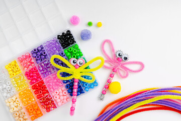 Beaded Pipe Cleaner dragonflies. Easy  kids crafts. Different multi-colored supplies and materials for DIY art activity for kids. Children's crafts, creativity and  hobby.
