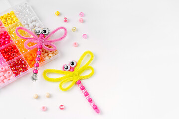 Beaded Pipe Cleaner dragonflies. Easy  kids crafts. Different multi-colored supplies and materials for DIY art activity for kids. Children's crafts, creativity and  hobby.