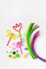 Beaded Pipe Cleaner flowers and dragonflies. Easy spring kids crafts. Different multi-colored supplies and materials for DIY art activity for kids. Children's crafts, creativity and  hobby.