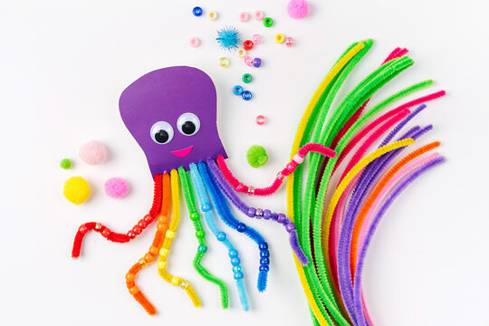 Funny octopus made of beads and pipe cleaners with different colorful and materials for DIY art activity for kids. Cute children's crafts, creativity and hobby. Development of fine motor skills