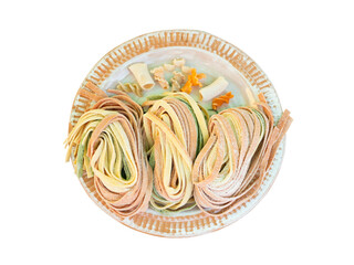 Colourful fresh paste noodle on plate isolated on white