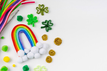 Rainbow and clover made of beads and pipe cleaners with different multi-colored  materials for DIY...