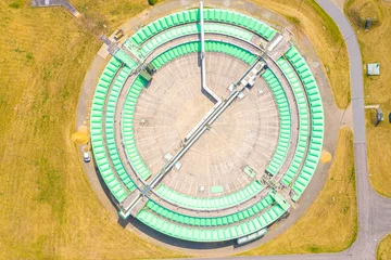 Fotobehang Aerial view of modern water cleaning facility at urban wastewater treatment plant. Purification process of removing undesirable chemicals, suspended solids and gases from contaminated liquid © netsay