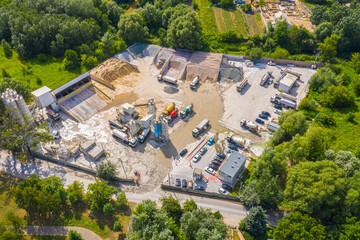 Fototapeta na wymiar Construction sustainable building materials bulk facility concrete cement granulate materials. Aerial drone view. Conveyor plant silos