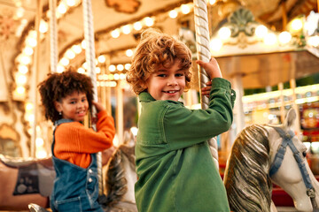 Kids having fun on a carnival Carousel