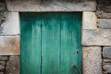 Granite stone facade with green door