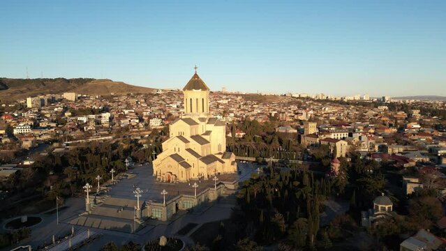 Aerial view of Holy Trinity Cathedral Sameba in Tbilisi Georgia. Sunset drone footage.