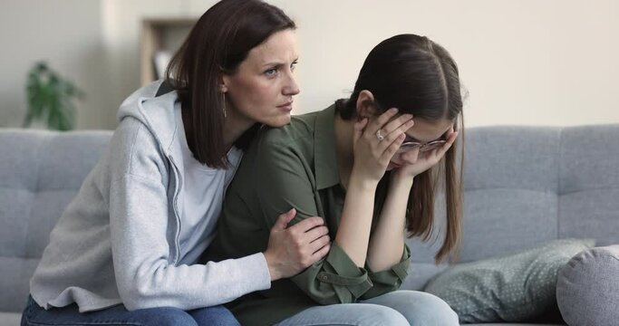 Loving concerned mum consoles upset teenager daughter feels unhappy, failed exam, unsuccessful college admission, first unrequited love, betrayal of friend, break up. Teen problem, motherhood, support