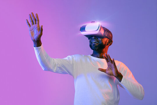 African american man experiencing virtual reality, using VR goggles