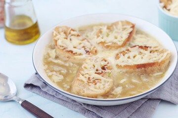 A ceramic bowl with French onion soup