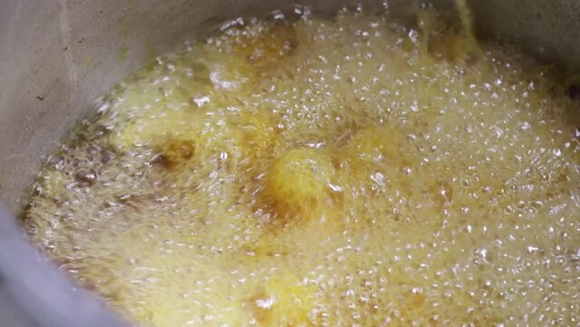 video of preparation of chicken broaster in abundant oil. Food preparation concept.