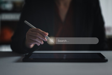 Concept of searching data networking and internet, Businesswoman wearing a suit holding digital pen...