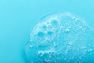 Transparent liquid with bubbles on blue background