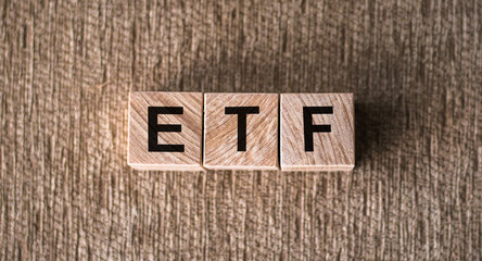 ETF - Exchange Traded Fund text on wooden cubes, on brown background