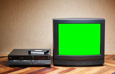 Old TV with a green screen and a VCR on the background of the wallpaper.
