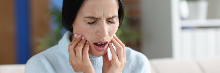 Young woman with severe acute toothache closeup - obrazy, fototapety, plakaty