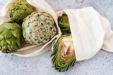 Top view of artichoke in linen eco bag on table. Flat lay of Healthy food vegetables