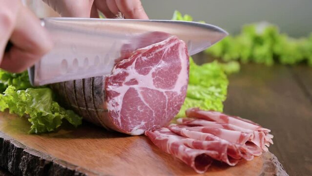 Capocollo or coppa is a traditional Italian and Corsican pork cut made from cured pork shoulder or neck. . Cut into very thin slices. Italian delicacy for aperitivo. Piacentina DOP. 4k footage