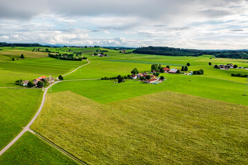 Naklejka premium Amazing wide aerial view from drone of beautiful green countryside, fields, road, and farms.