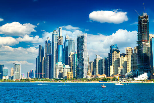 Sunset view of the Dubai Marina and JBR area and and golden sand beaches in the Persian Gulf. Holidays and vacations in the UAE