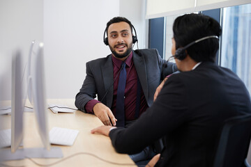 businessman or operator talking about work to colleagues at call center service in the office