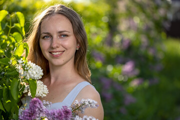 Portrait Girl with Flowers Lilac in the Garden in Spring