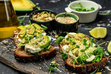 avocado toasts with cheese, pumpkin, nut and sesame. Healthy fats, clean eating for weight loss