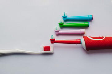 electric toothbrush with colored nozzles on a colored background