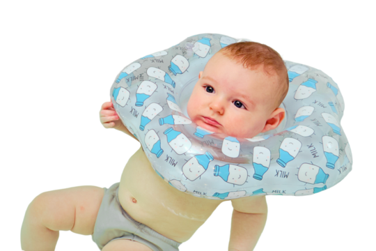 Infant swimming, a boy swims in a home bath with an inflatable ring on his neck, isolated on a white background. Kid aged four months