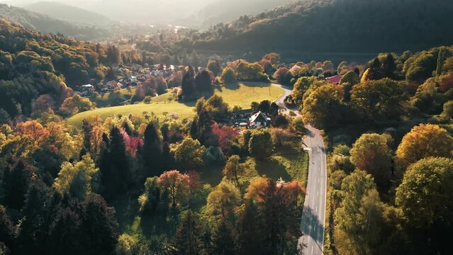 Idyllic landscape in Germany, aerial cinematic footage of the beautiful nature and a village in pleasing warm colors