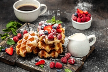 Berry Belgian Waffle with raspberries, strawberries and blueberries. Culinary, cooking, bakery concept. Food recipe background. Close up