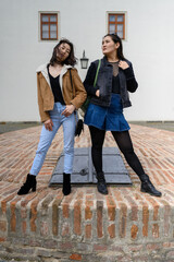 Two Asian women tourist enjoying vacation in old town. Girl traveler walking in an Czech city. Fashion tourist concept. 