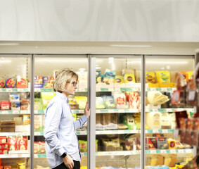 man choosing a dairy products at supermarket.