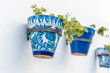 Flower pots decorating typical Andalusian houses in Mijas, Spain - obrazy, fototapety, plakaty